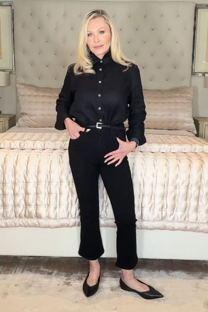 Over 60 fashion blogger wearing a black button down shirt with black kick flare jeans as an example of Affordable ageless fashion for women over 50.